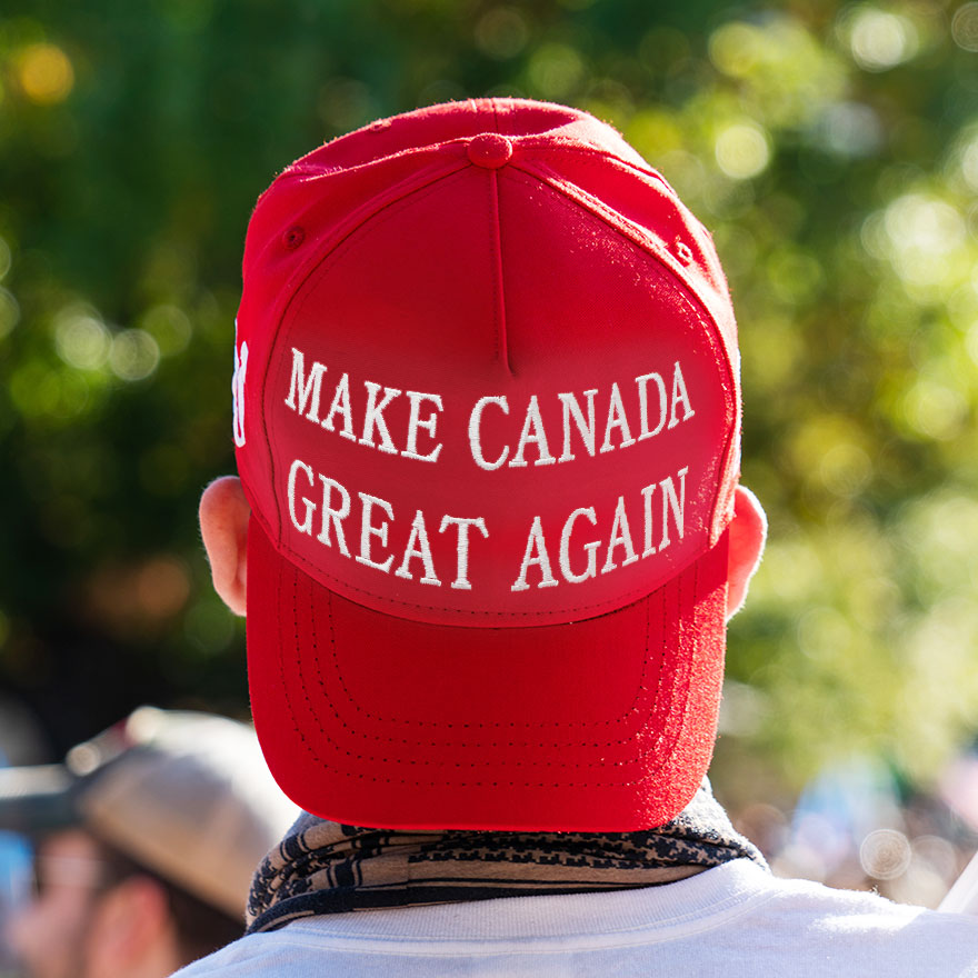 A man wearing a red "Make Canada Great Again" hat.