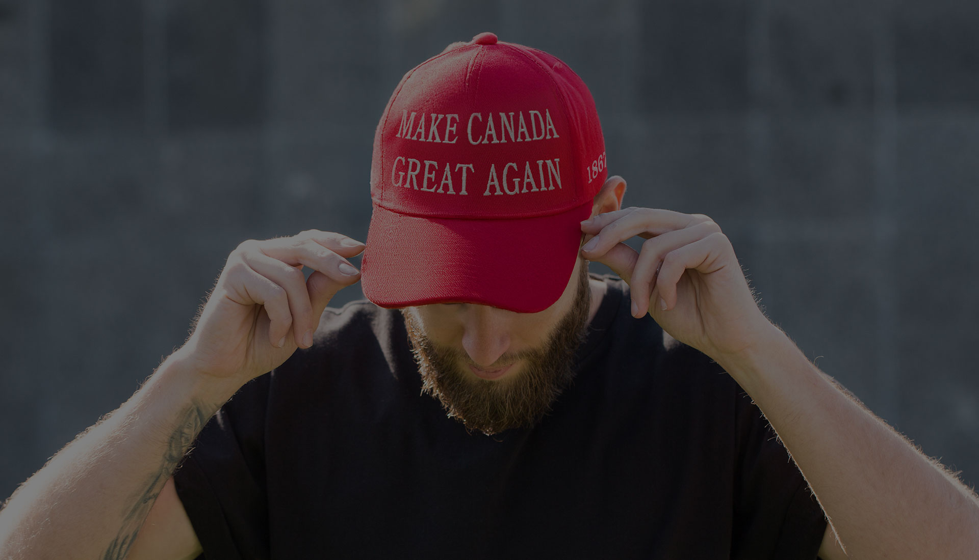 A guy wearing a red "Make Canada Great Again" hat.