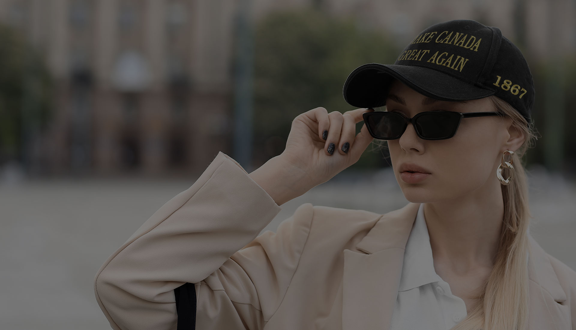 A girl wearing a black "Make Canada Great Again" hat.